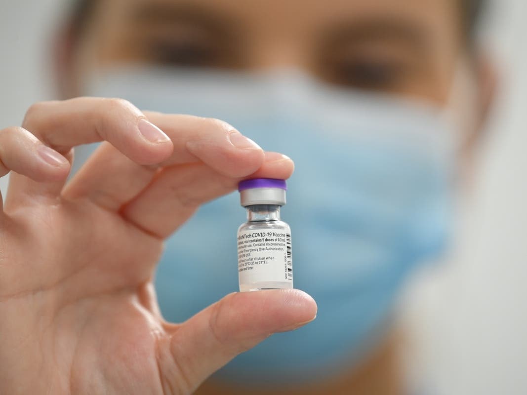 CARDIFF, WALES - DECEMBER 08: A member of staff poses with a phial of Pfizer-BioNTech Covid-19 vaccine at a vaccination health centre on the first day of the largest immunisation programme in the UK's history on December 8, 2020.