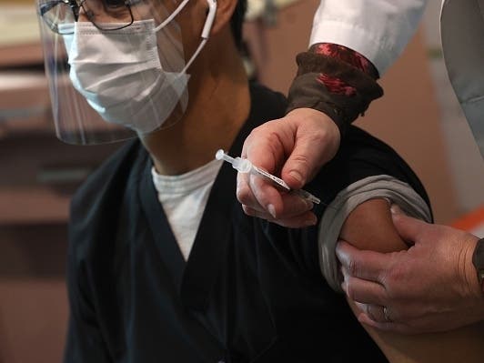 MARTINEZ, CALIFORNIA - DECEMBER 15: Frontline healthcare worker Gilberto Garcia receives a Pfizer COVID-19 vaccination at Contra Costa Regional Medical Center on December 15, 2020 in Martinez, California. 