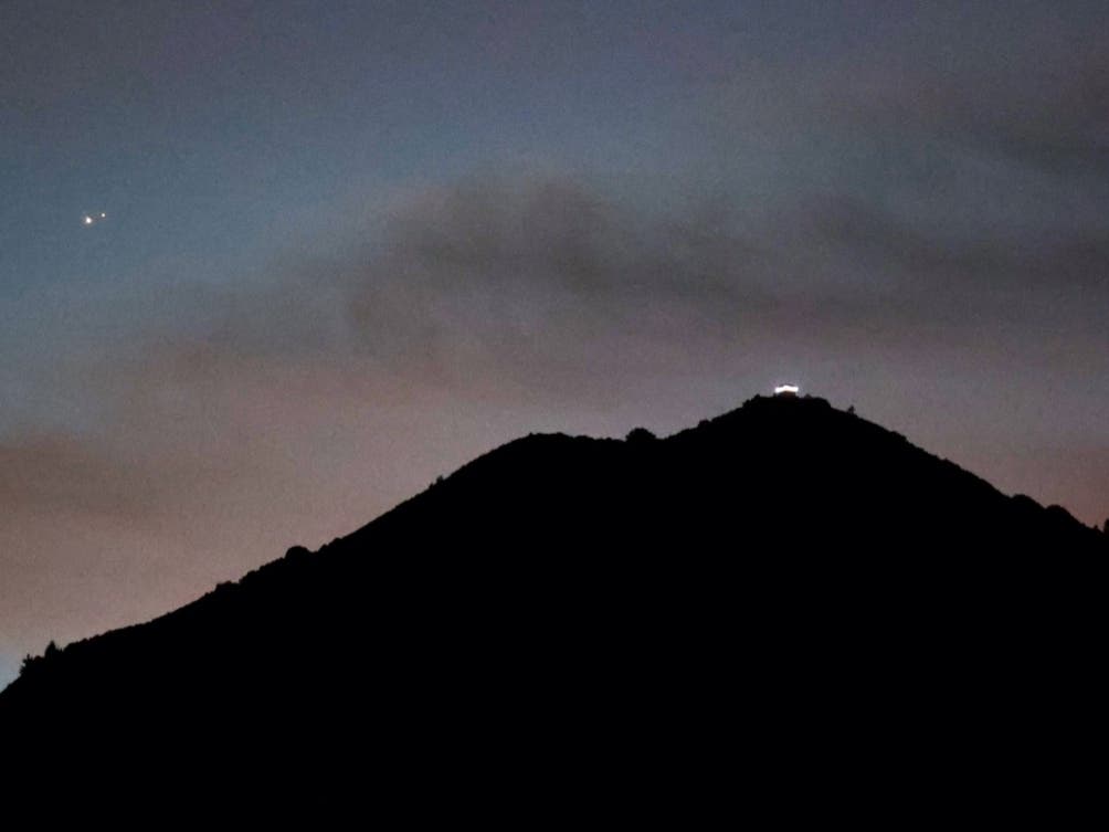 LARKSPUR, CA - DECEMBER 21: Jupiter (L) and Saturn appear about one-tenth of a degree apart during an astronomical event known as a Great Conjunction above Mt. Tamalpais on December 21, 2020 in Larkspur, California. 