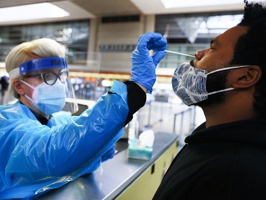 A man receives a nasal swab COVID-19 test at Tom Bradley International Terminal at Los Angeles International Airport (LAX) amid a coronavirus surge in Southern California on December 22, 2020 in Los Angeles, California. 