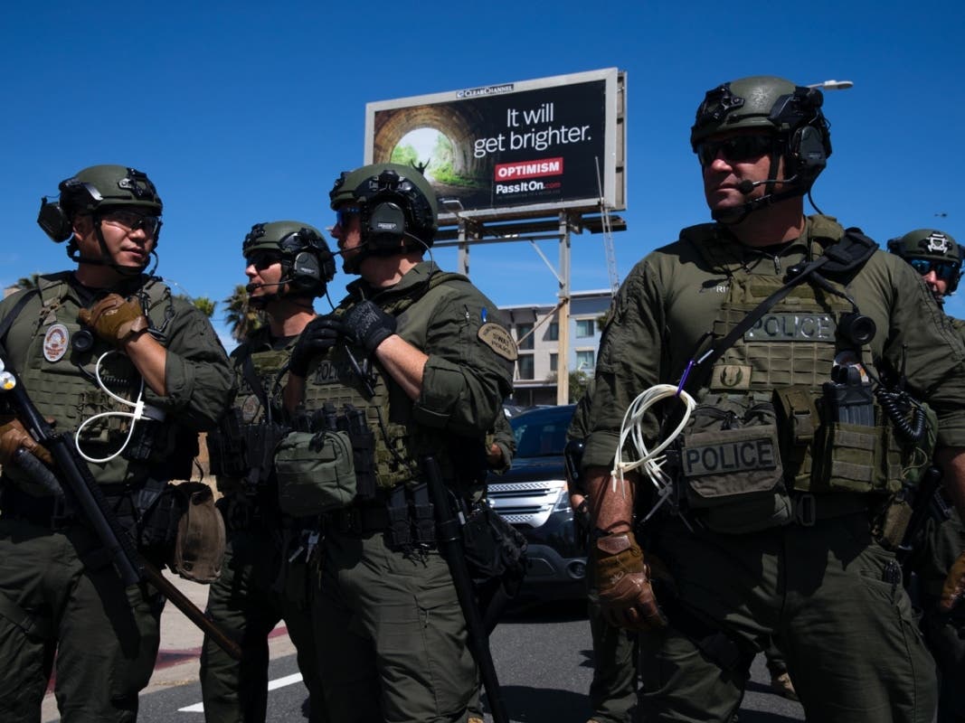  Huntington Beach SWAT team members stand ready for protesters after violent demonstrations in response to George Floyd's death on May 31, 2020 in Huntington Beach, California. 