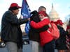 Gary Phaneuf, Tony Naples and Melody Black share a moment together as they visit a memorial setup near the U.S. Capitol Building for Ashli Babbitt who was killed in the building after a pro-Trump mob broke in on January 07, 2021 in Washington, DC. 