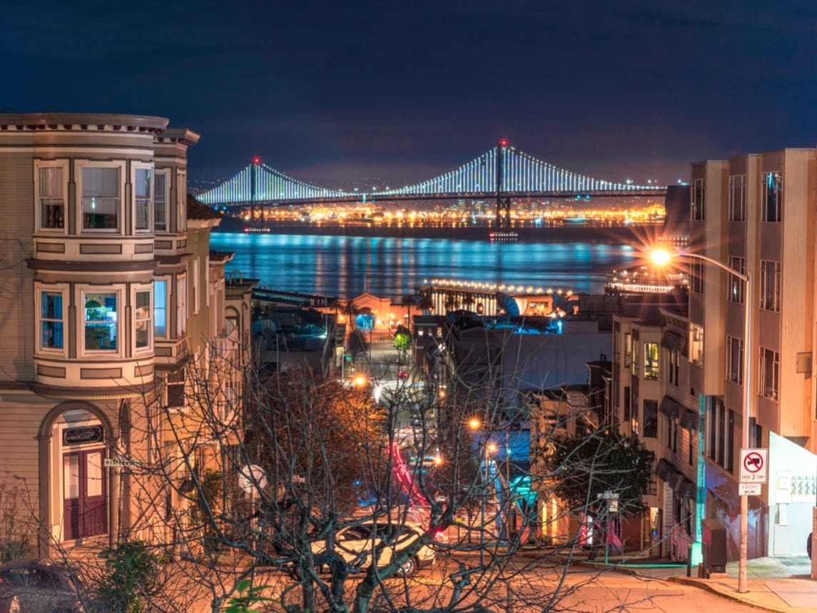 A night view looking towards Oakland and the San Francisco Bay Bridge from the Telegraph Hill district of San Francisco after dusk.