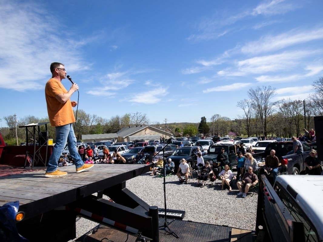 Pastor Greg Locke of Global Vision Bible Church in Tennessee holds services in the church parking lot in March 2020, defying orders from Gov. Bill Lee prohibiting social gatherings of 10 or more. Locke will speak Friday night at Bayshore Community Church.