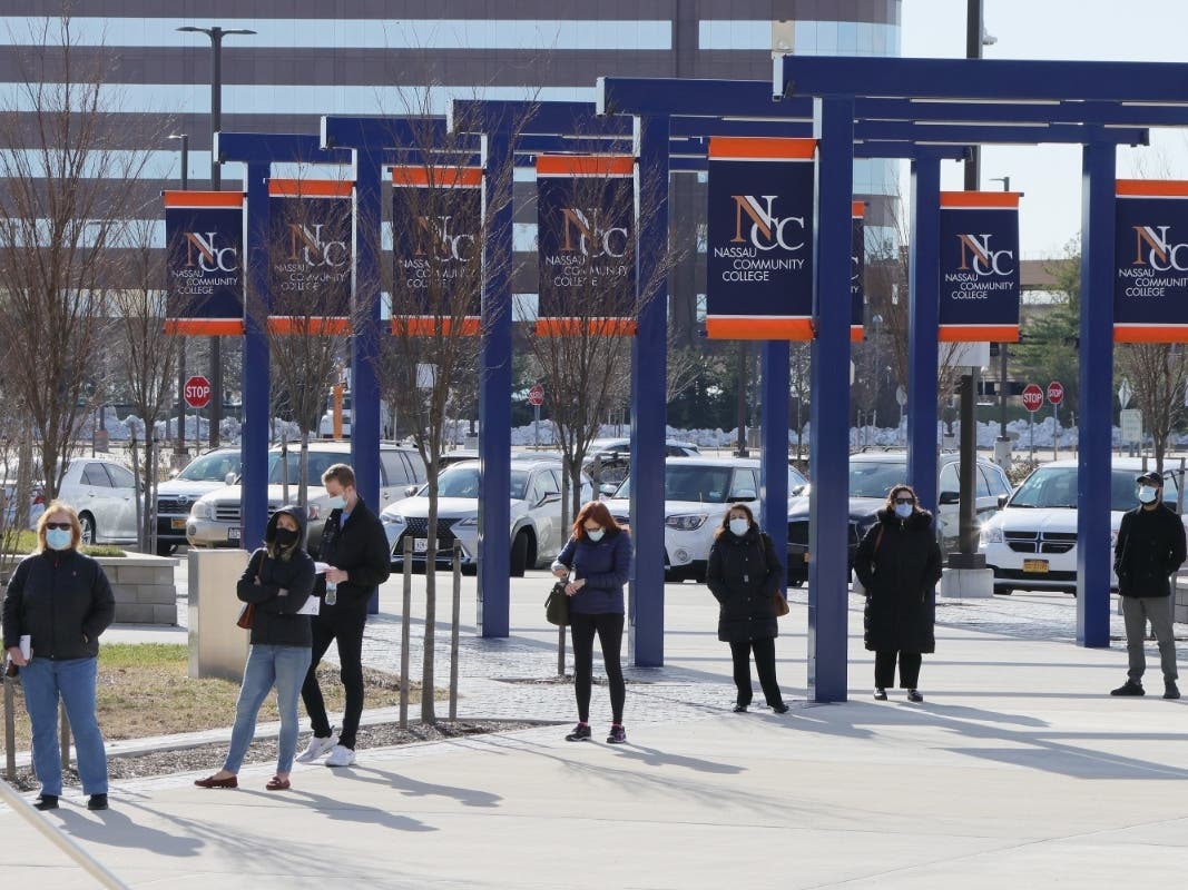 People line up for COVID-19 vaccinations at Nassau Community College on Jan. 10 in Garden City, New York. 