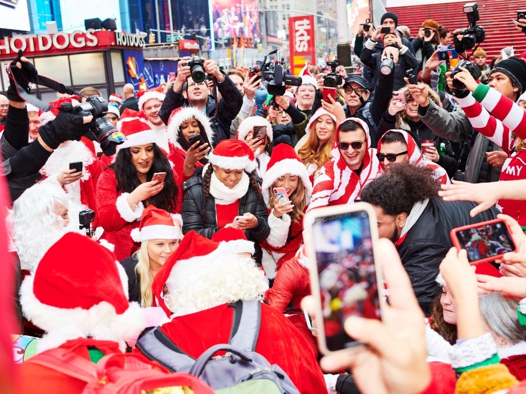  People dressed as Santa Claus gather at Father Duffy Square for SantaCon on December 14, 2019, in New York City. Every year, people dress up as Santa Claus or in other holiday-themed costumes, and drink at multiple bars across the city.