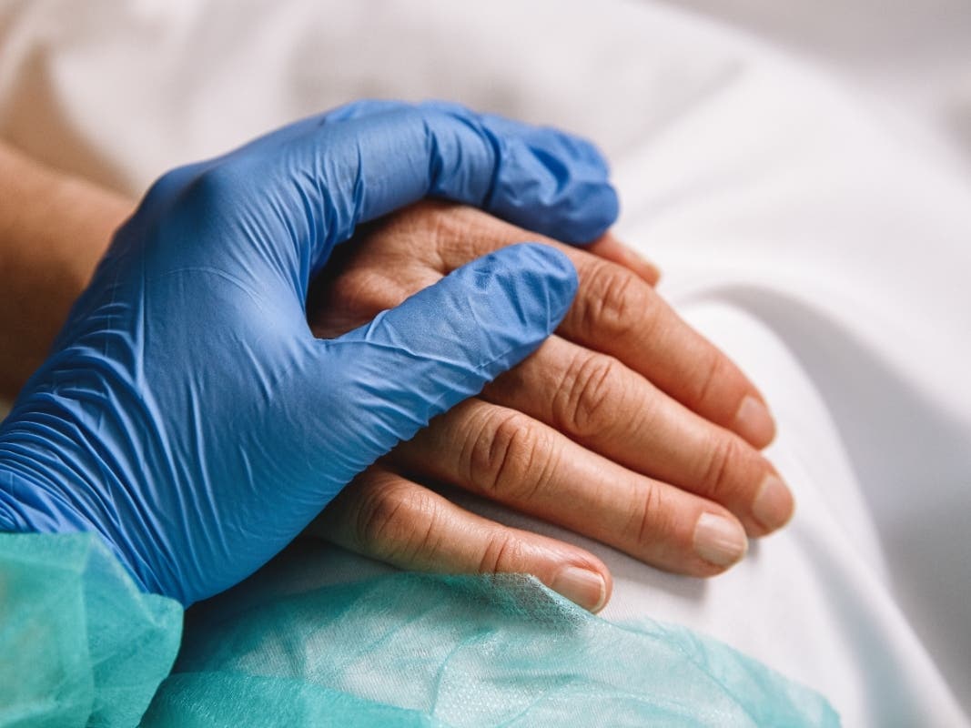 A file photo of a healthcare worker giving support to a patient.