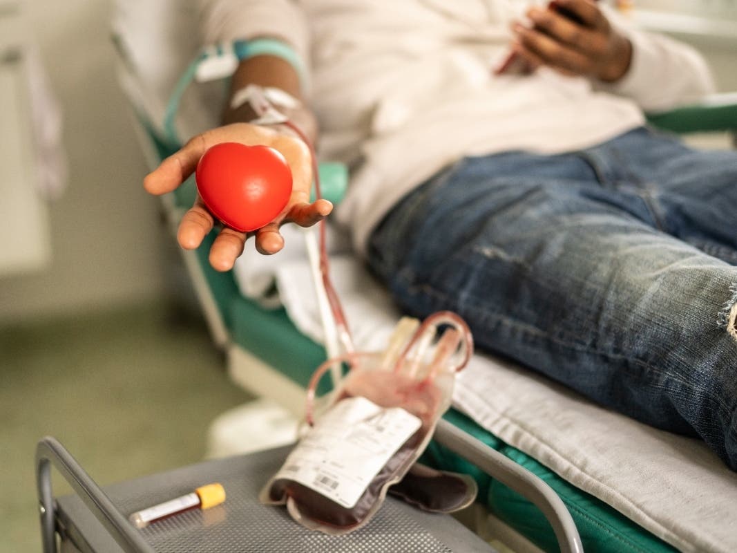 A file photo of donor squeezing the heart-shaped ball during blood donation.