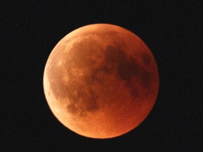 A lunar eclipse occurs when the Earth comes between the sun and the moon, blocking the sunlight from falling on the moon, which takes on a dark reddish or blood color.