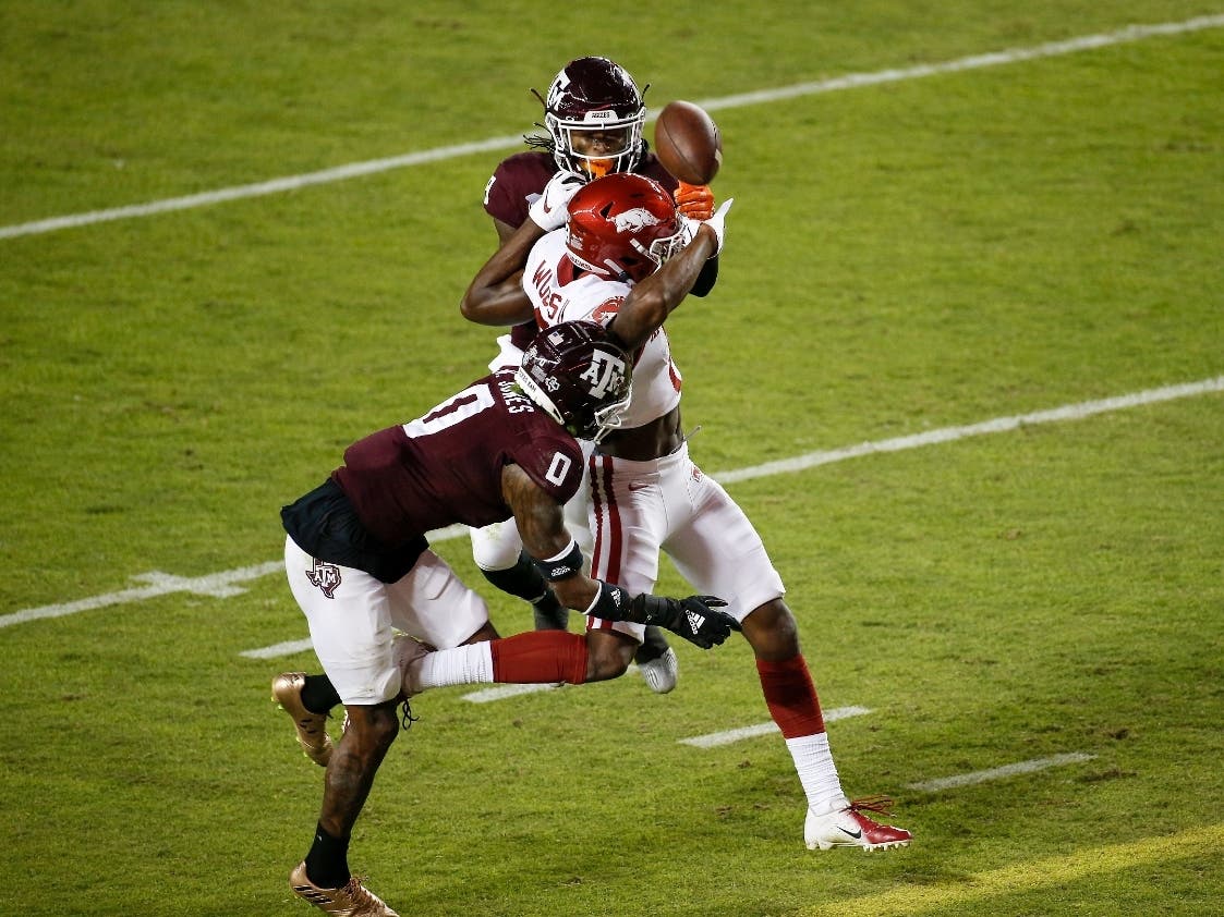 Texas A&M defensive back Myles Jones (0) break up a pass intended for Arkansas' Mike Woods (8) in the third quarter at Kyle Field on Oct. 31, 2020 in College Station, Texas. Jones went to Magnolia West High School, and Woods went to Magnolia High School.