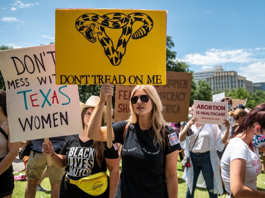Protesters hold up signs at a protest outside the Texas state capitol on May 29 in Austin, Texas. Thousands of protesters came out in response to a new bill outlawing abortions after a fetal heartbeat is detected signed Wednesday by Gov. Greg Abbott.