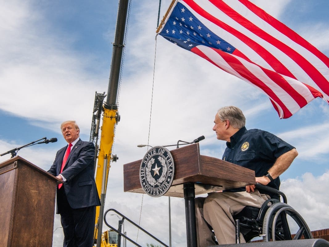 Texas Gov. Greg Abbott listens to former President Donald Trump during a tour to of the unfinished border wall on June 30 in Pharr, Texas. Abbott announced an election audit of Harris County and three others hours after Trump called for an audit in Texas.