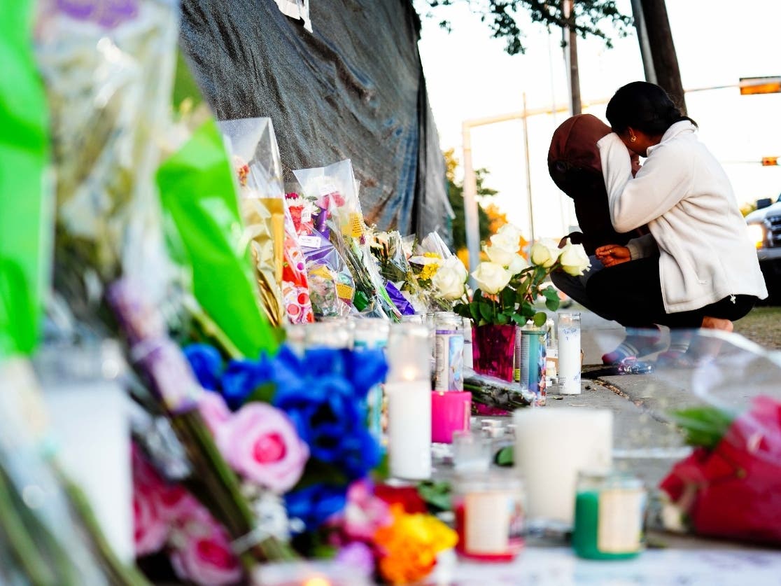 Visitors look at the memorial outside of the canceled Astroworld Festival at NRG Park on Sunday in Houston.