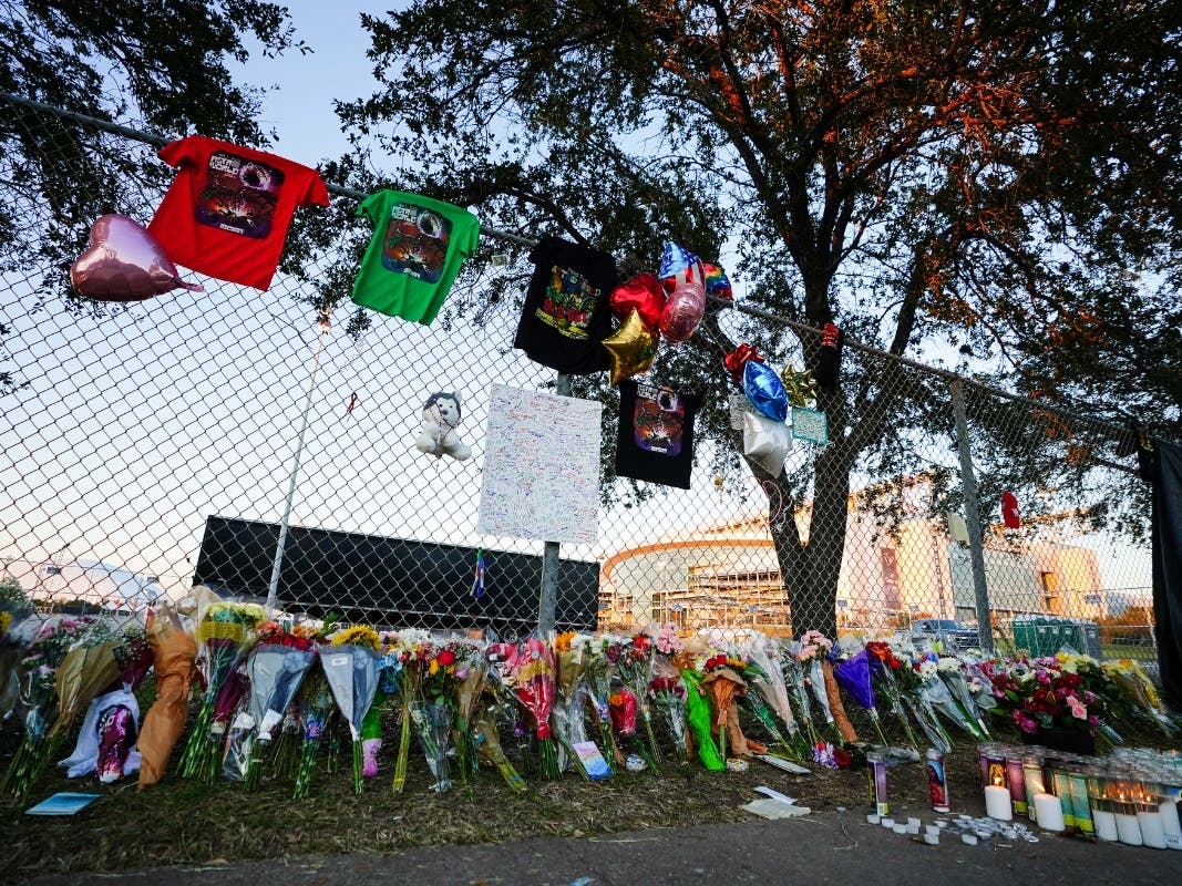 Candles, flowers and letters are placed at a memorial outside of the canceled Astroworld festival at NRG Park on Sunday in Houston. 