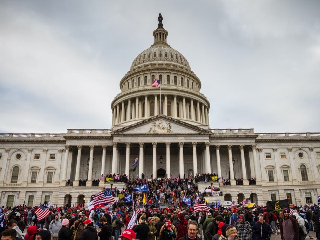 A large group of pro-Trump protesters stand on the East steps of the Capitol Building after storming its grounds on January 6, 2021 in Washington, DC.