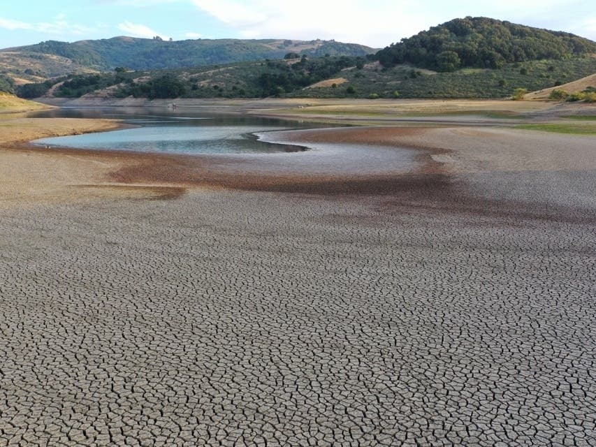 In an aerial view, dry cracked earth is visible at Nicasio Reservoir on June 16, 2021 in Nicasio, California. 