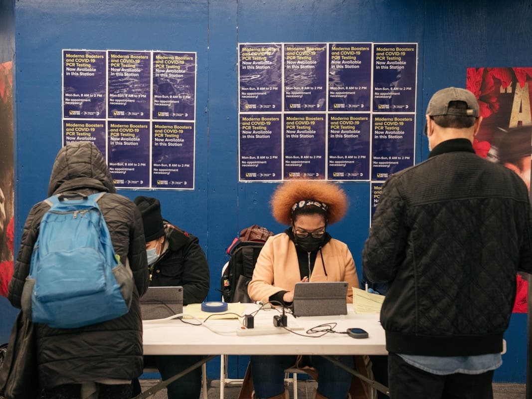 Commuters wait in line to recieve a nasal swab COVID-19 test at a new testing site inside the Times Square subway station on December 27, 2021 in New York City. 