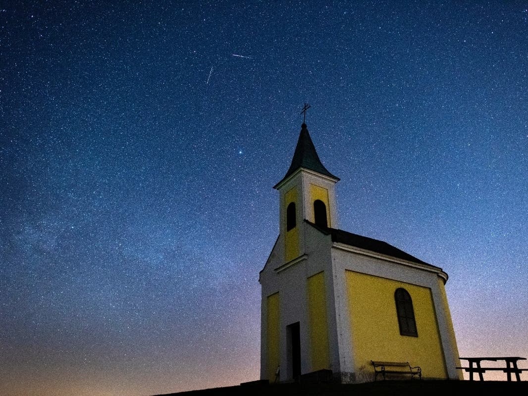 The Lyrids meteor shower streaks across the sky over Michaelskapelle on April 21, 2020 in Niederhollabrunn, Austria.
