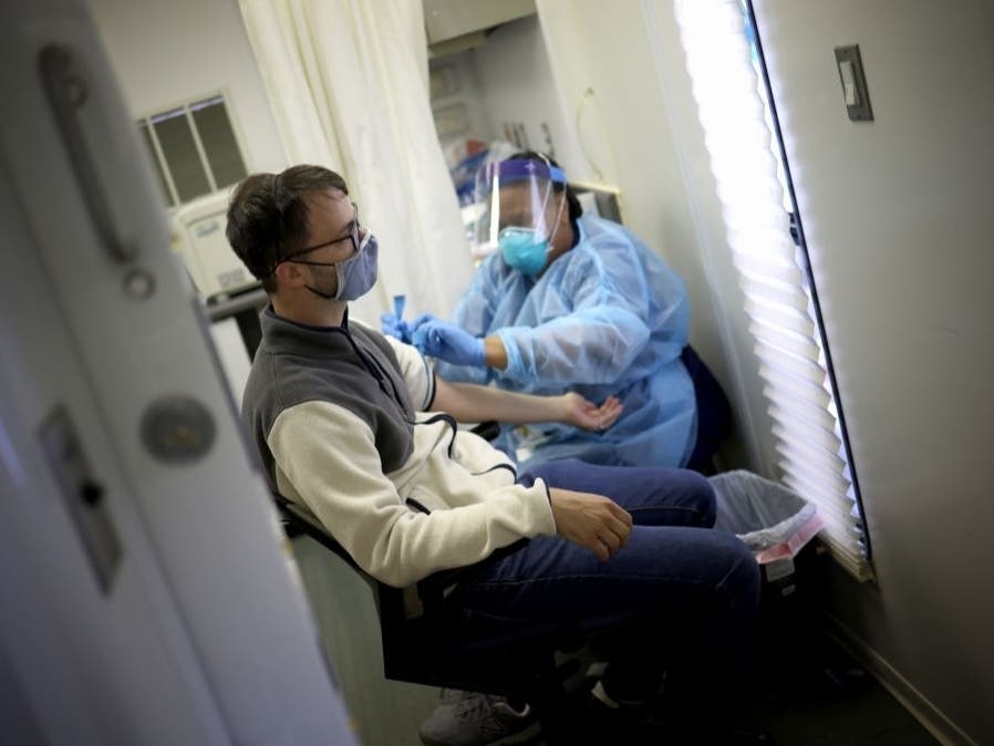 A man has his blood drawn for an antibody test for the coronavirus, also called a serology test. A new report says a record 5.4 million Americans have lost health insurance amid the coronavirus pandemic.