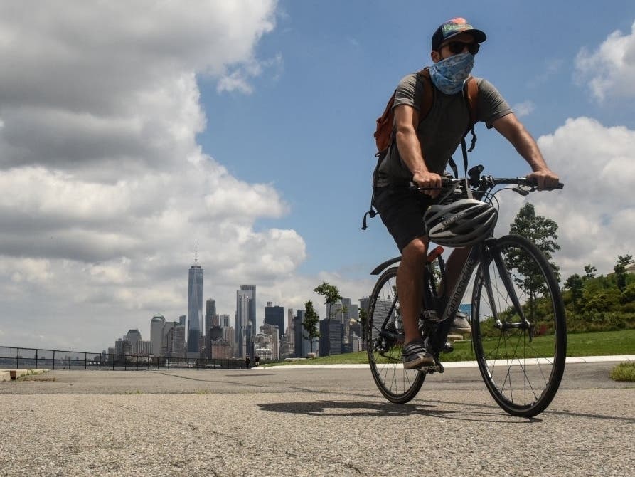 A person rides a bike on Governors Island in New York City. Governors Island reopens to visitors on Wednesday with limited capacity due to continued concerns about the coronavirus.