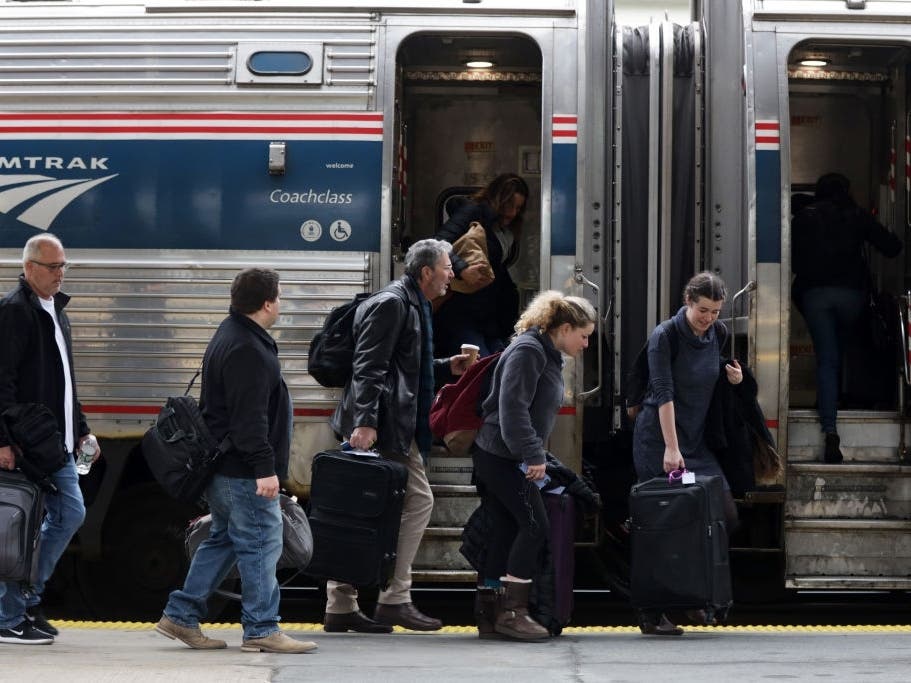 Passengers wait to board an Amtrak train at Union Station in Washington, D.C. The company plans to furlough close to 2,000 employees by the end of September, according to reports.