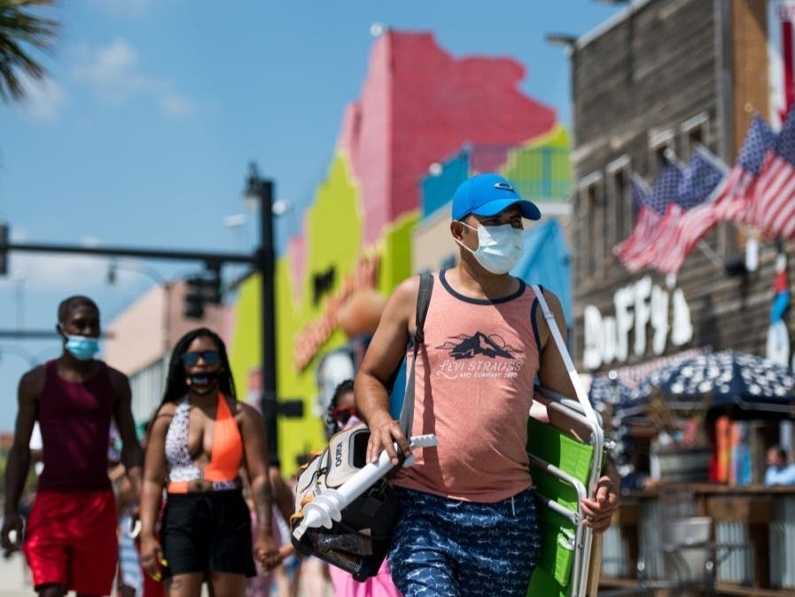 People walk to the beach in Myrtle Beach, South Carolina. The Labor Day weekend marks an end to a COVID-19 hampered summer tourist season.