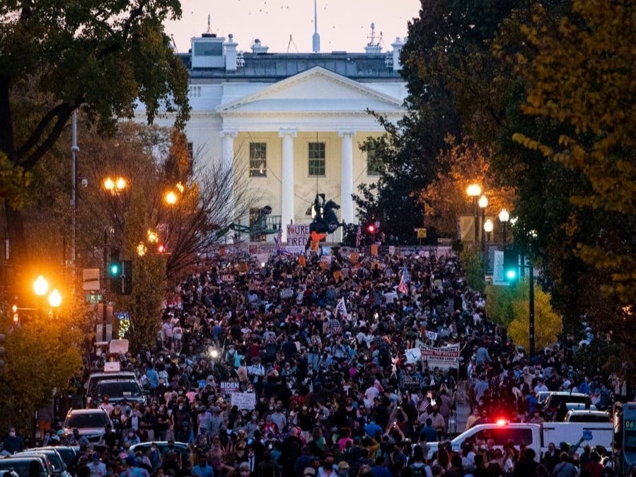 People gather in Black Lives Matter Plaza near the White House as they celebrate after Democratic nominee Joe Biden was declared winner of the 2020 presidential election.