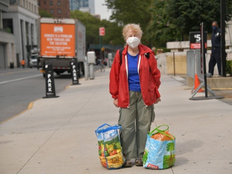 A food bank has their photo taken after picking up goods from their pop-up food pantry during Hunger Action Month at Lincoln Center in New York City. Help combat hunger this World Kindness Day.