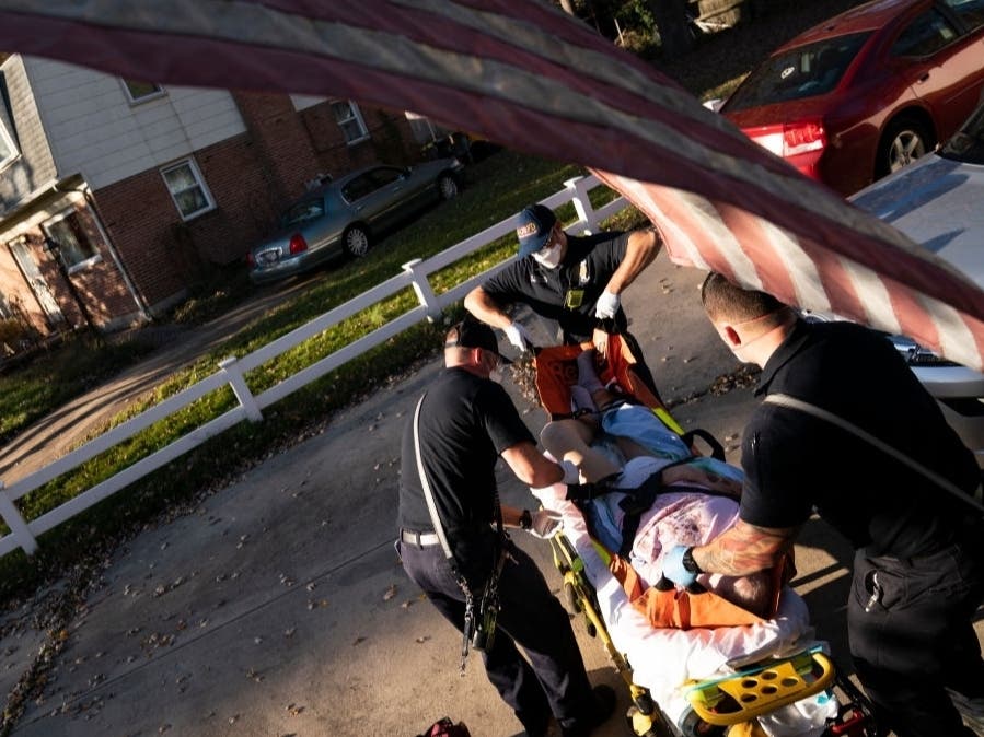 Paramedics and firefighters with Anne Arundel County Fire Department prepare to transport a patient to the hospital in Glen Burnie, Maryland. 