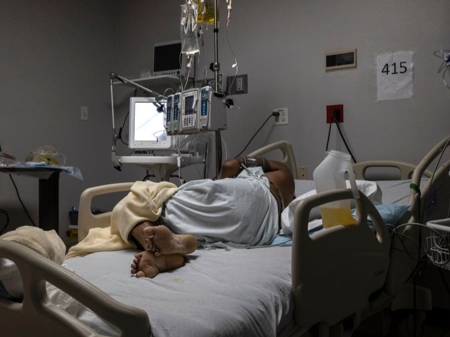  A patient is seen lying on a bed in the COVID-19 intensive care unit at United Memorial Medical Center in Houston. The United States has surpassed 20.5 million cases of coronavirus and more than 351,000 deaths.