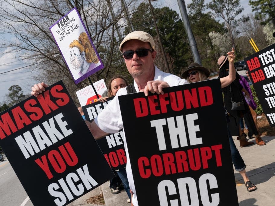 People are seen at a protest against masks, vaccines, and vaccine passports outside the headquarters of the Centers for Disease Control on March 13, 2021, in Atlanta, Georgia.