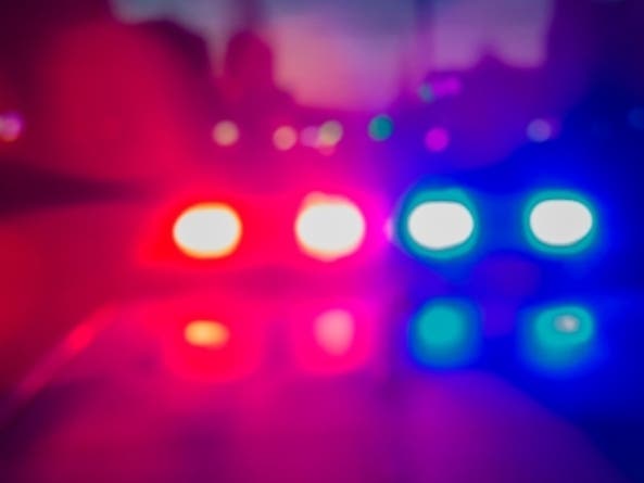 Lights of police car in night time. Night patrolling the city, lights flashing. Abstract blurry image.