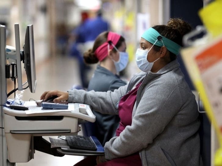 More than 1,700 in Maryland are currently hospitalized with the coronavirus, state health officials said Thursday, April 30. Pictured, nurses work outside the room of a coronavirus patient at MedStar St. Mary's Hospital.