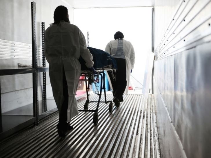 The remains of a coronavirus victim are wheeled from a refrigerated truck trailer at Holy Cross Hospital in Germantown. More people have died from COVID-19 in Montgomery County — which has reported 576 deaths as of May 25 — than anywhere else in Maryland.