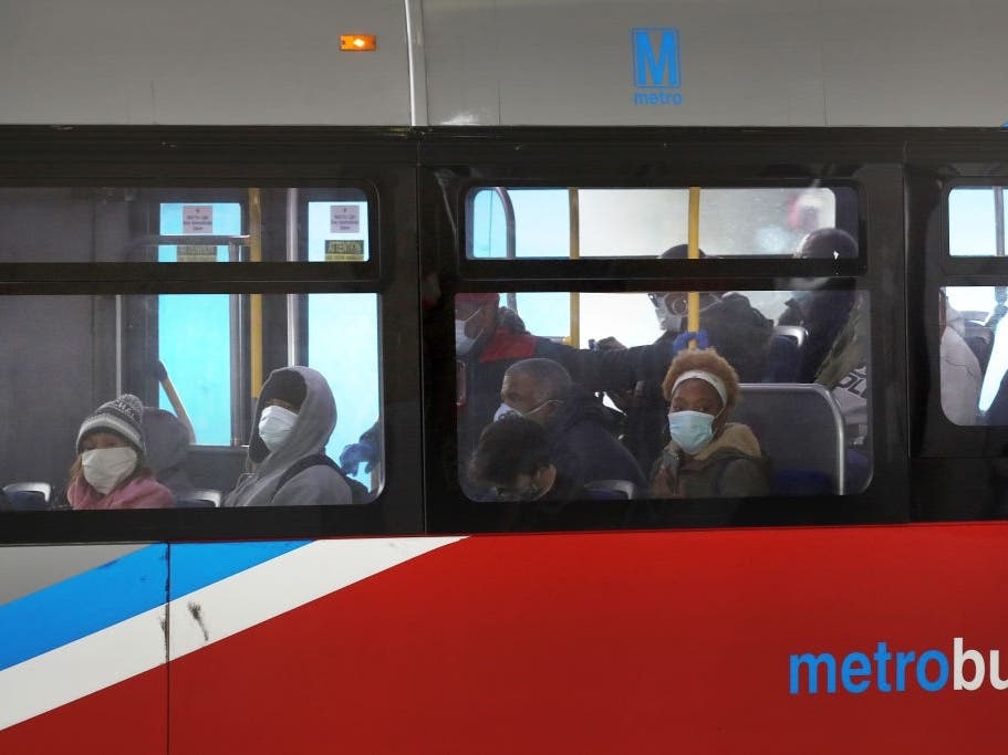 Commuters wear mandatory face coverings while riding a bus at the Sarbanes Transit Center in Silver Spring.