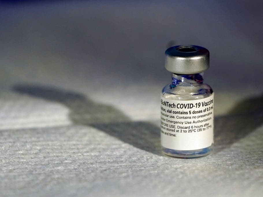 A health care worker holds up a vial of the Pfizer vaccine. Hospitals across Maryland are planning to administer the vaccine to front-line health care workers.