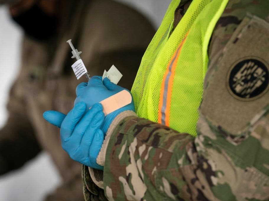 A member of the National Guard prepares to inject people with the coronavirus vaccine in the parking lot of Six Flags on Feb. 6 in Prince George's County.