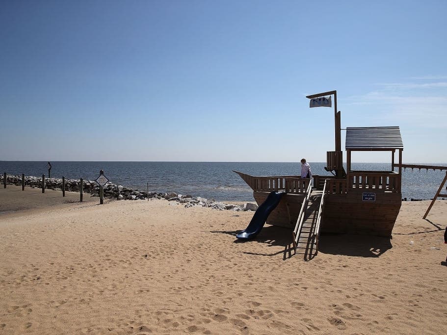 Children play on a wooden ship on the shore at North Beach, Maryland.