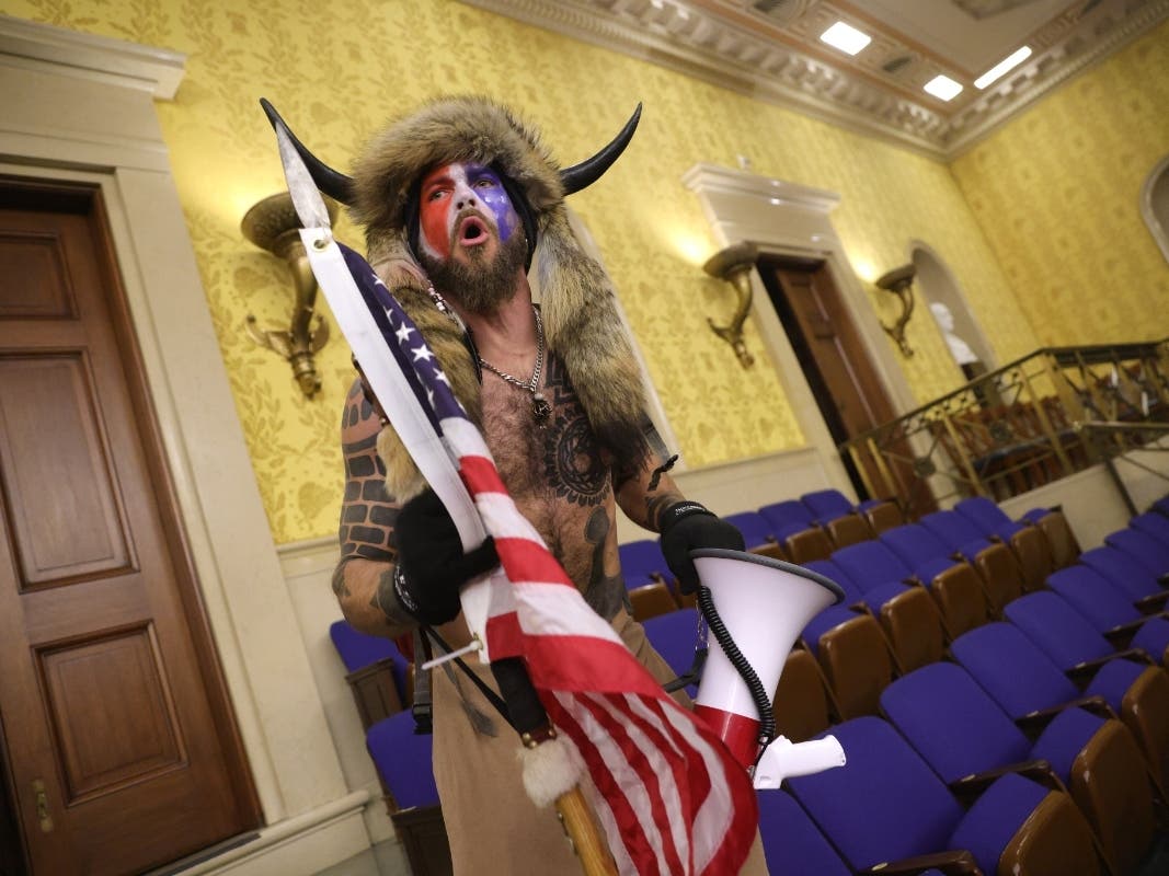 A protester screams "Freedom" inside the Senate chamber after the U.S. Capitol was breached by a mob during a joint session of Congress on January 06, 2021 in Washington.