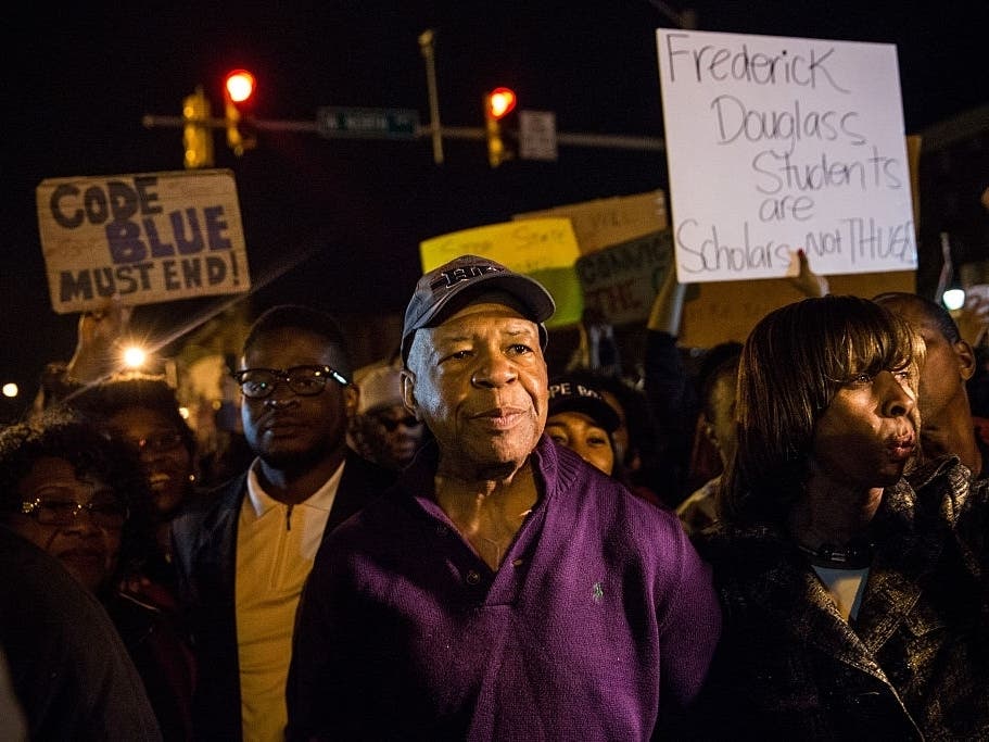U.S. Rep. Elijah Cummings helps clear the streets of protesters when Baltimore State's Attorney Marilyn J. Mosby announced charges would be filed against Baltimore police officers in the 2015 death of Freddie Gray.