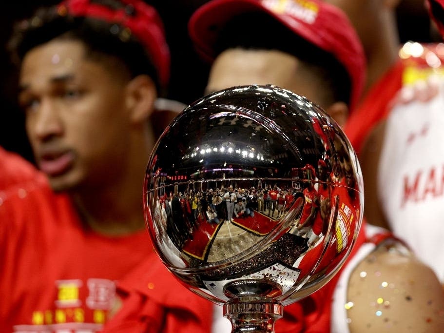 Members of the Maryland Terrapins celebrate with the trophy after defeating the Michigan Wolverines 83-70 to clinch a share of the Big Ten regular season title at Xfinity Center on Sunday in College Park, Maryland.