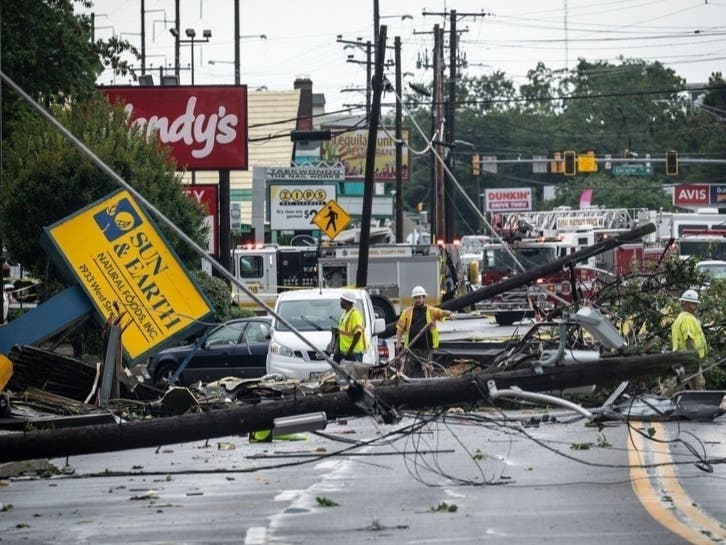 Comcast utility workers survey the damage from a tornado on West Street in Annapolis on Sept. 1. The remnants of Hurricane Ida spawned the EF-2 tornado that was on the ground nearly 12 miles from Edgewater to Annapolis.