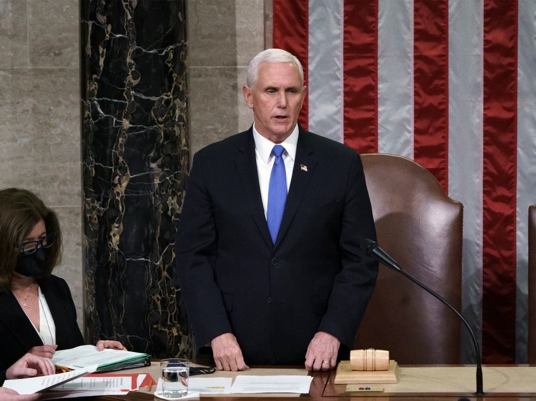 JANUARY 07: Vice President Mike Pence reads the final certification of Electoral College votes cast in November's presidential election during a joint session of Congress, after working through the night, at the Capitol on January 7, 2021 in Washington DC