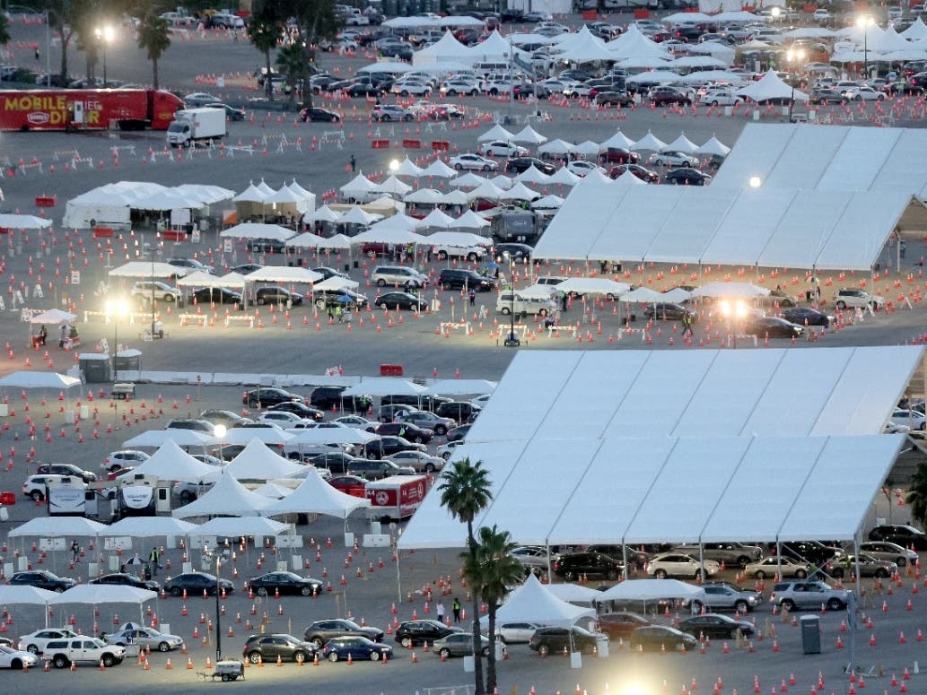 Cars are lined up at the mass COVID-19 vaccination site at Dodger Stadium on February 23, 2021 in Los Angeles, California. The site, one of the largest vaccination sites in the country.