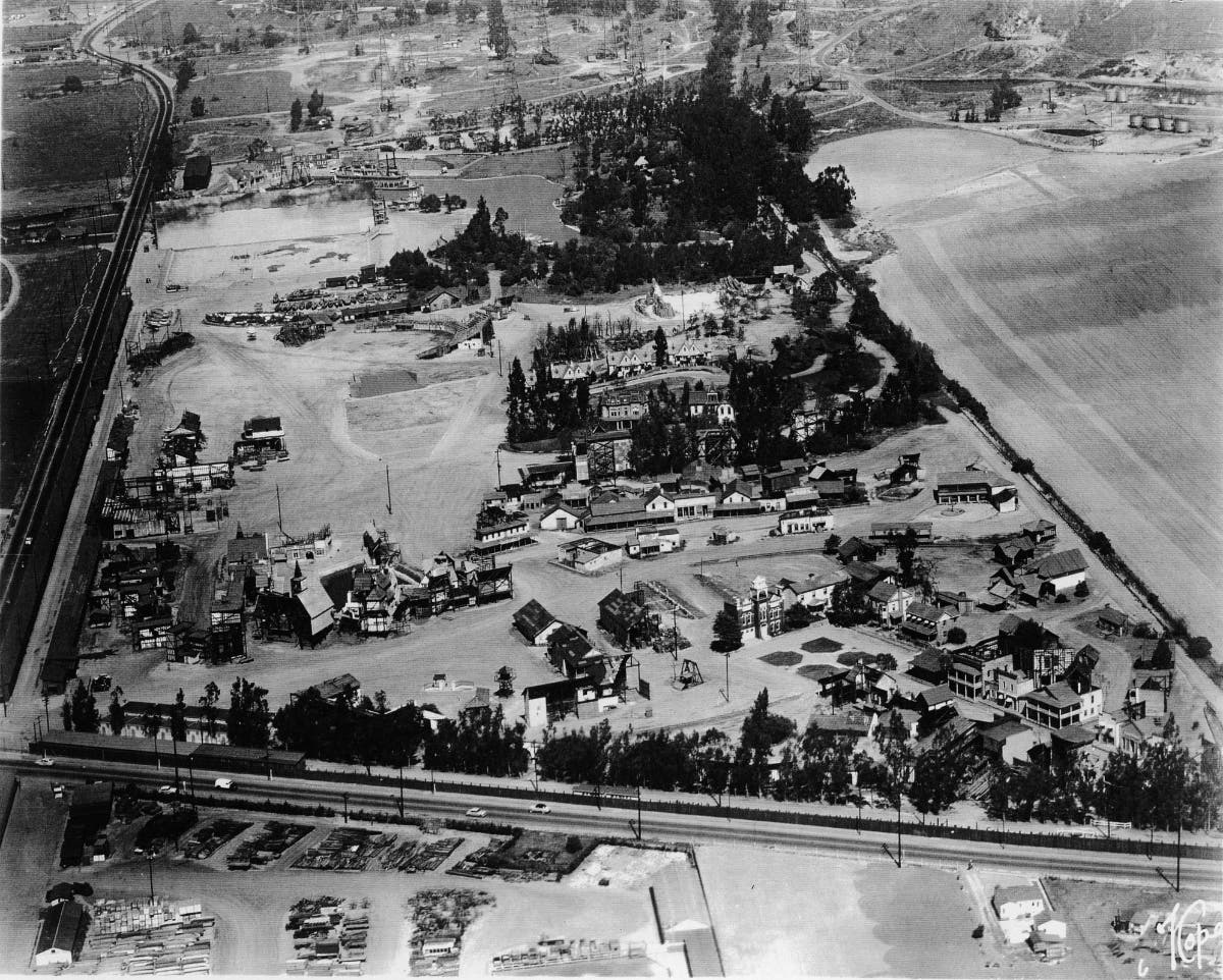 Aerial view of a Metro-Goldwyn-Mayer (MGM) film studio backlot in the early 1950s. Visible are a number of sets from various films, including the riverboat from the 1951 version of 'Show Boat' and the HMS Bounty from the 1935 version of