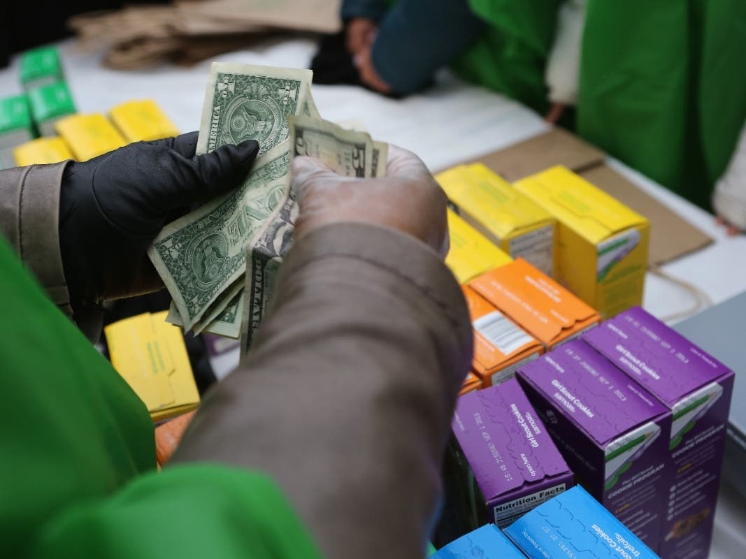 File Photo: Money is collected as Girl Scouts sell cookies while a winter storm moves in in 2013.