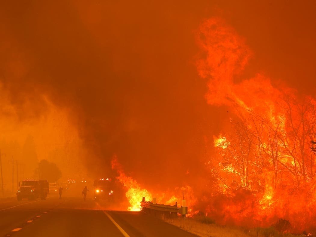 The Dixie Fire burns along Highway 395 near Milford on Tuesday.