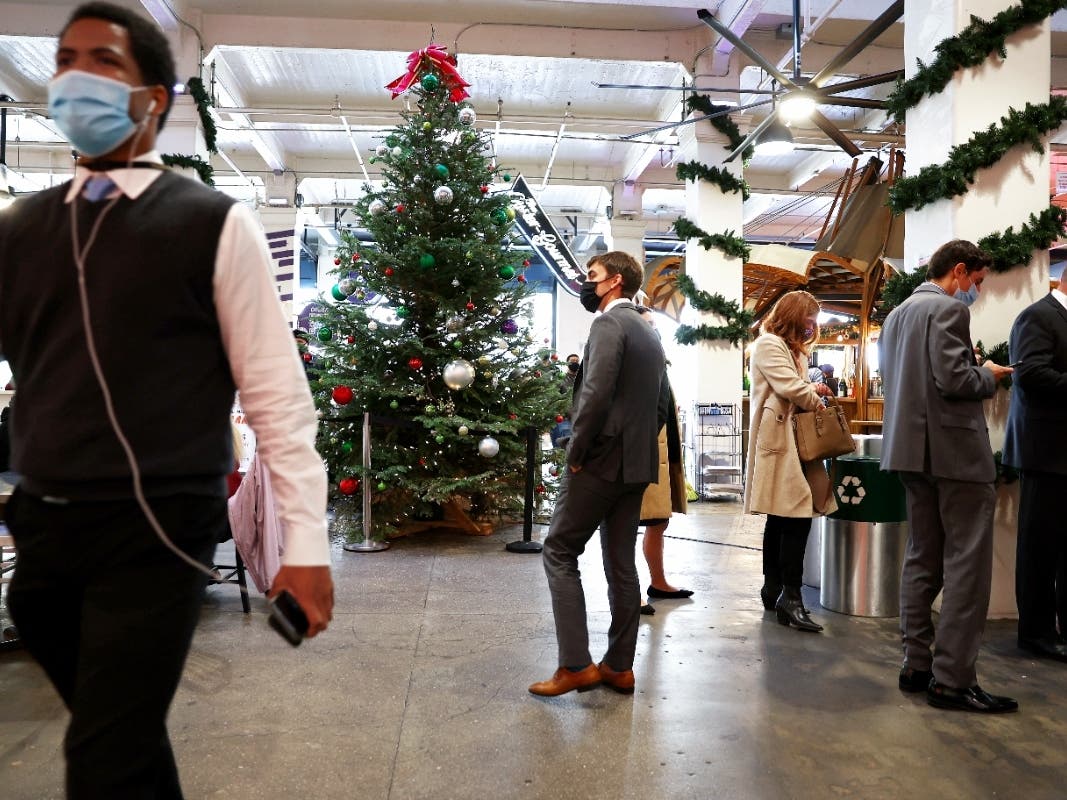 People wear face coverings inside Grand Central Market on December 15, 2021 in Los Angeles, California. California residents, regardless of COVID-19 vaccination status, are required to wear face masks in all indoor public settings beginning today.