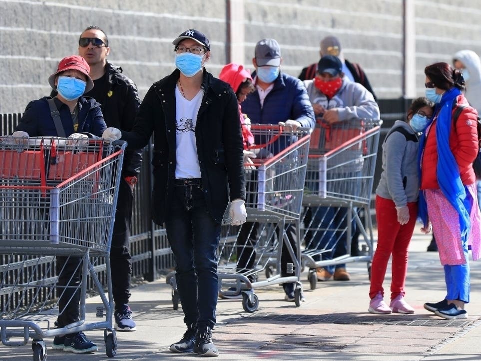 Customers, most wearing masks or face coverings, wait in line to enter the Industry City Costco store  in the Brooklyn borough of New York City. Beginning Monday, May 4, all customers and employees will be required to wear masks or other face coverings.