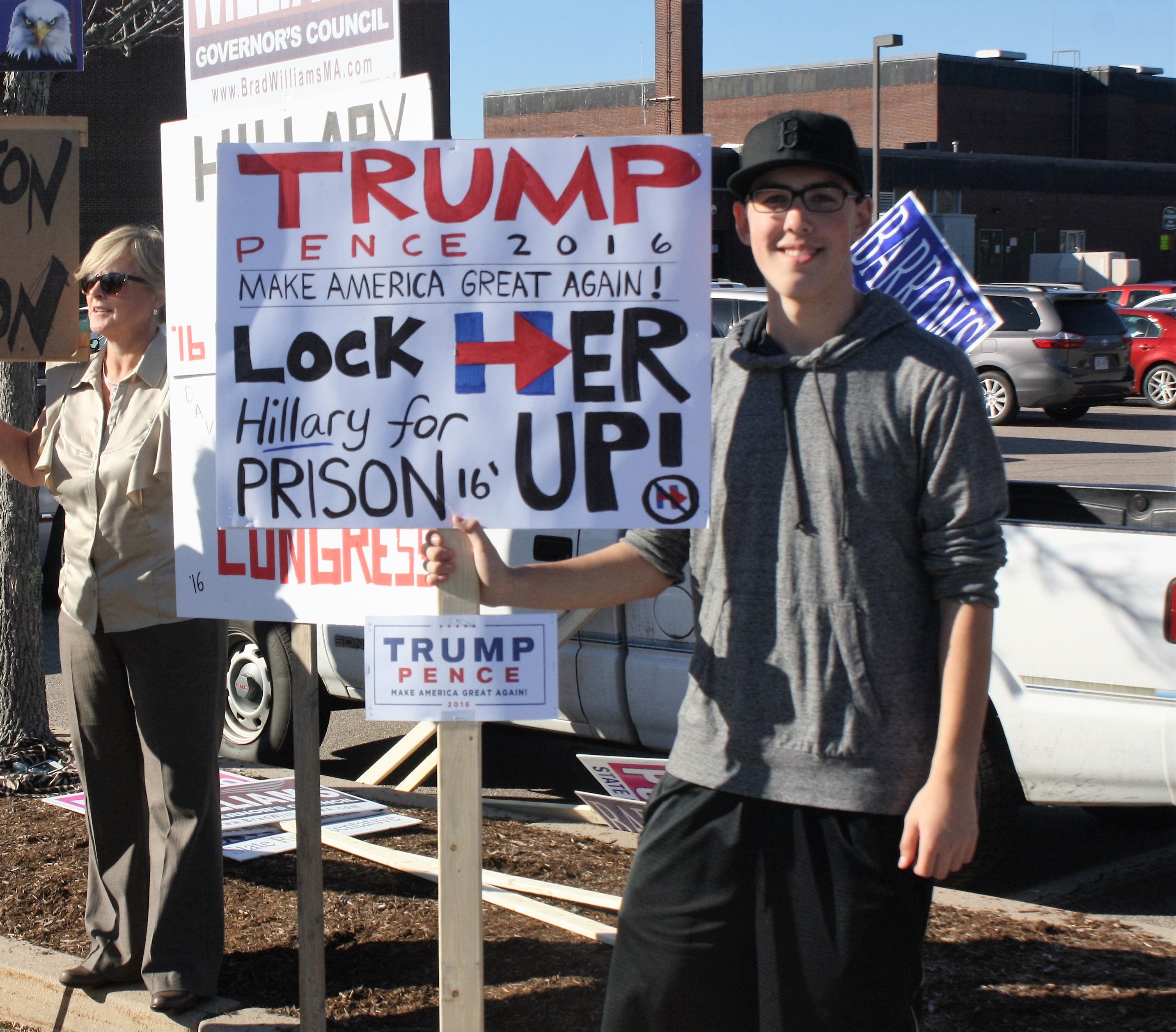 Matt Hannon holds a sign he made,